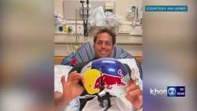 World champion surfer Kai Lenny holding his cracked helmet 'It may have saved my life'