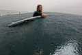 SURFING IN A RAIN STORM AT PIPELINE 